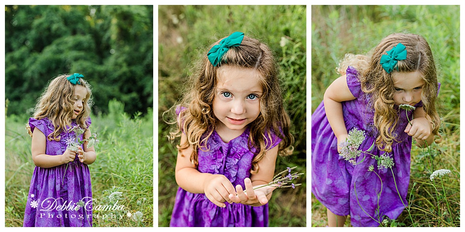 Little girl in purple dress picking flowers in a field in Mountainside, NJ