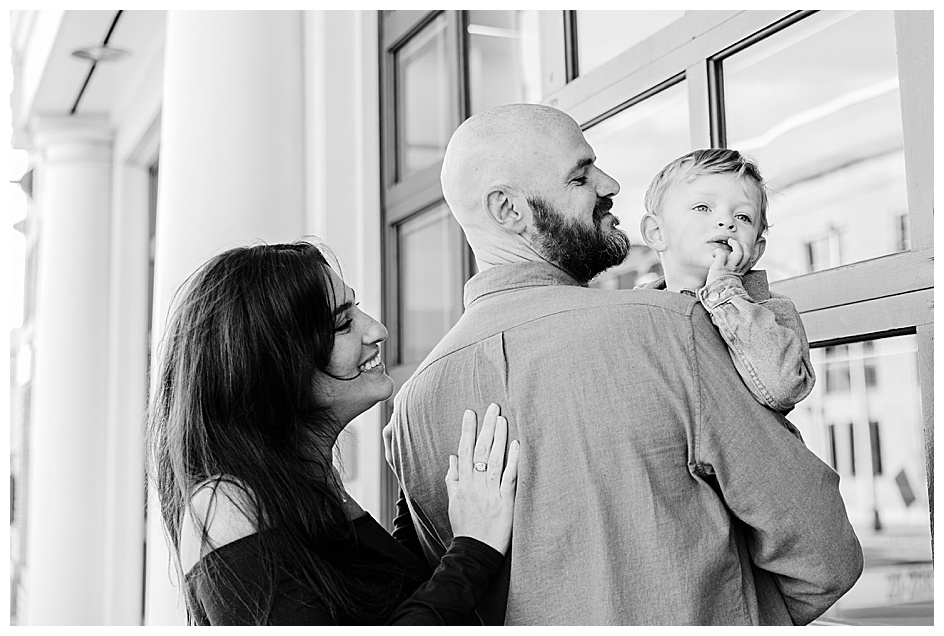black and white image of sweet little boy in father's arms nj lifestyle family photographer