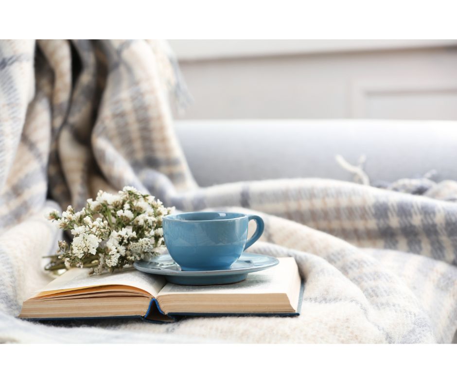 tea cup on book on sofa image for favorite books 2023