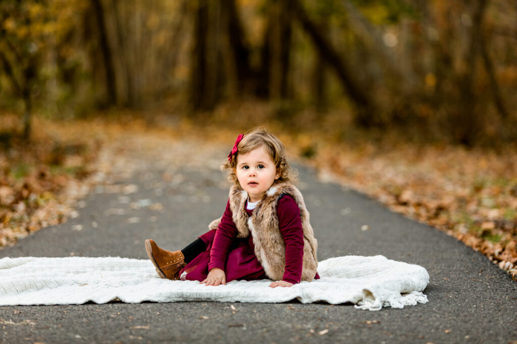 Little girl sitting on a blanket in Lenape Park, Westfield, NJ
