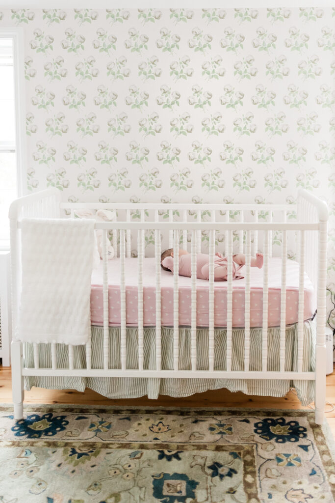 Baby girl in crib in English Countryside inspired nursery in Basking Ridge