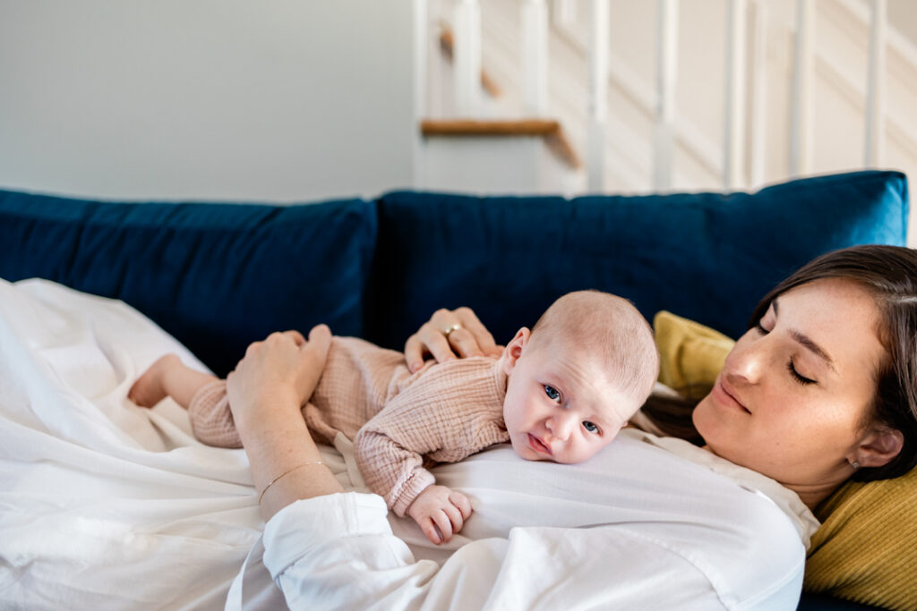 Newborn baby girl laying on mother