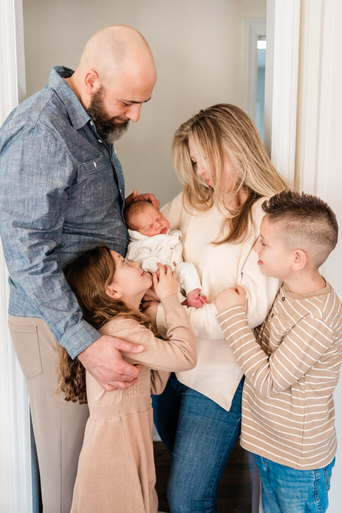 Family looking lovingly at newborn baby