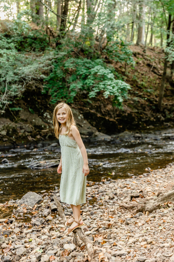 Young girl standing near a stream in summer in Somerset County, NJ
