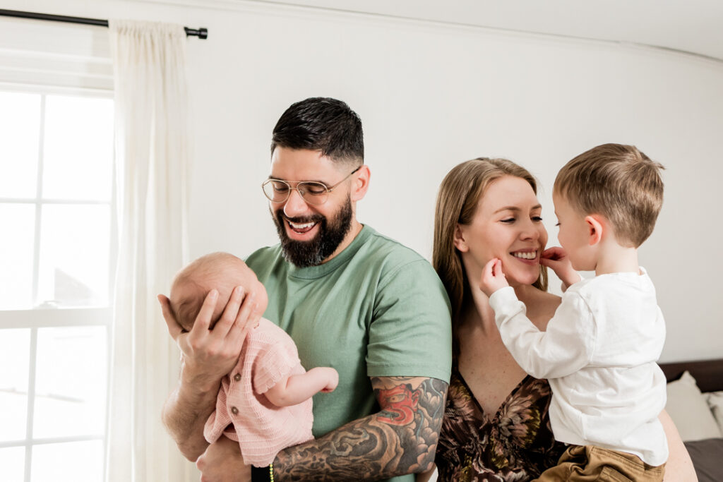 joyful family enjoying newborn photoshoot
