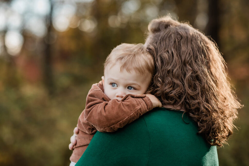 Mother comforting her thoughtful toddler boy 