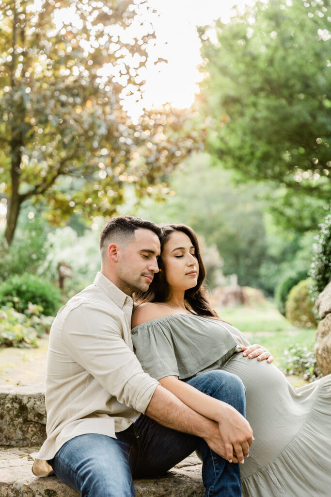 An expecting couple enjoying a quiet moment together during their maternity photoshoot.